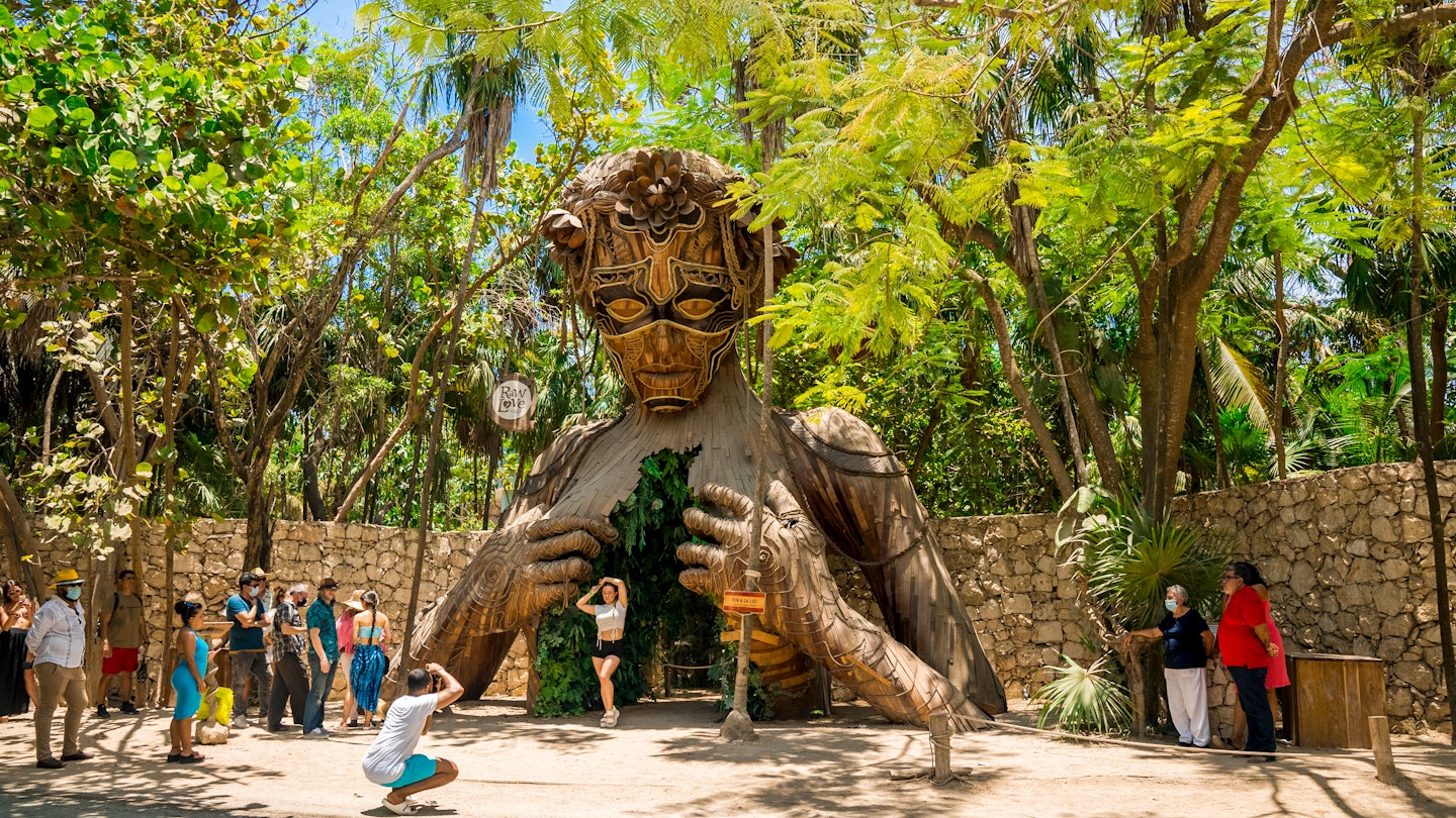 Tulum, Mexico. May 20, 2021.Beautiful towering wooden sculpture called "Ven a La Luz" welcomes guests onto the beach at Ahau Tulum in Mexico.; Shutterstock ID 1981632350; your: Ann Douglas Lott; gl: 65050; netsuite: Digital Content; full: Tulum beaches article refresh
